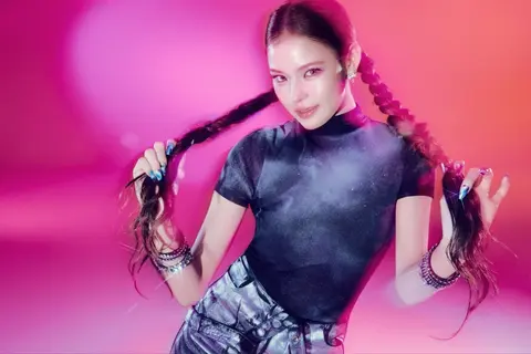 MAI holding her braids